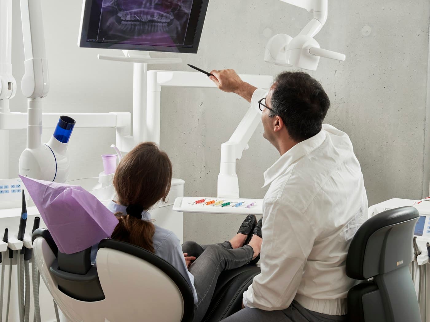 A dentist talking a patient through their treatment plan